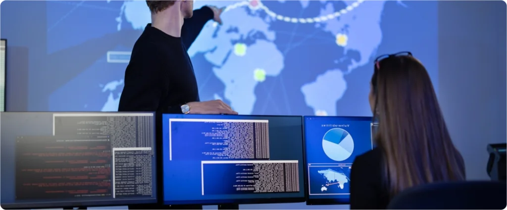 Cybersecurity analysts monitoring global threat intelligence on multiple screens at TrustVault, supporting compliance with the Personal Data Protection Act Sri Lanka.